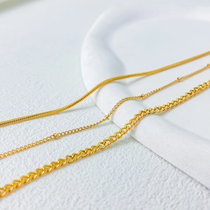 Three-layer gold titanium steel necklace set with snake, bead, and curb chain links