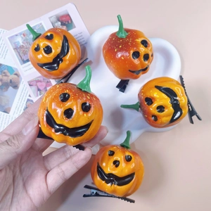 Set of five orange Halloween pumpkin hair clips with cute jack-o-lantern faces and clips