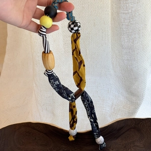 Ethnic bohemian necklace with printed fabric, acrylic beads, and wooden heart pendant