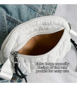 Detailed macro view of the large capacity rear pocket and lining on white quilted bag