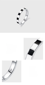 Macro shot of S925 hallmark on minimalist silver ring with black and white enamel pattern