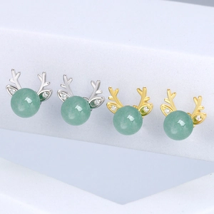 Close-up of antler earrings in silver and gold plating with green aventurine beads