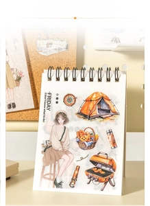 Detail of spiral-bound sticker book featuring smooth page turning and camping illustrations