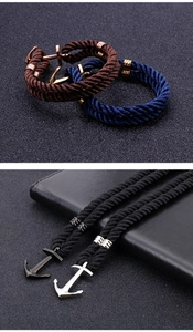 Detailed view of woven nylon ropes with gold and silver anchor clasps for men's bracelets