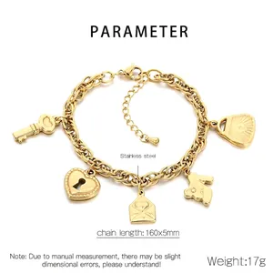 Macro shot of gold stainless steel heart and key charms on a beaded fashion bracelet