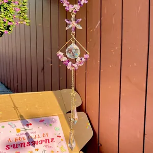 Amethyst suncatcher with crystal ball and geometric frame hanging on wood
