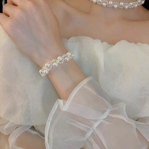 Detail of handcrafted multi-layer faux pearl and crystal choker on female model