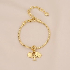Detail of travel charm bracelet with gold airplane, globe, and postcard pendants