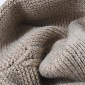 High-quality close-up of soft camel ribbed knit beanie fabric texture for winter warmth