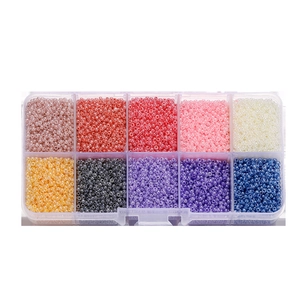 Macro shot of a 10-grid storage box filled with colorful glass seed beads for DIY jewelry