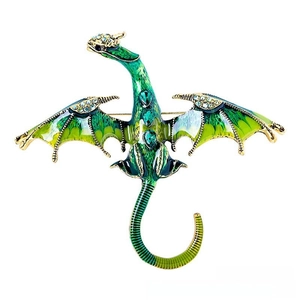 Close-up of green gradient dragon brooch with emerald stones and crystal accents