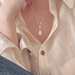 Close-up of 925 silver irregular pendant necklace with OT clasp on a female model