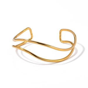 Modern wide gold-plated stainless steel open bangle with irregular wavy texture