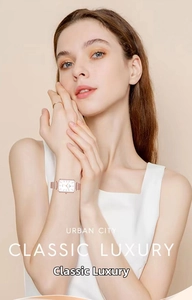 Close-up of elegant rose gold square quartz watch with mesh strap on a female wrist