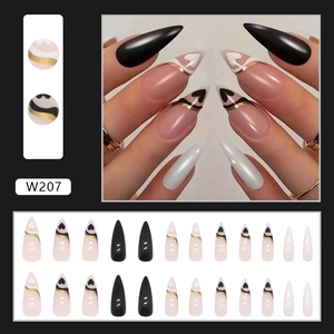 Detail of 24pcs long stiletto press on nails featuring black, white and nude heart designs