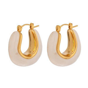 Close-up of elegant gold U-shaped earrings with translucent milky resin detail