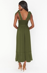 Detailed back view of dark green midi dress with smocking and bow tie straps