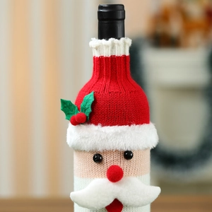 Close-up of a festive knitted Santa wine bottle cover with holly and 3D beard details