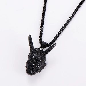 Close-up of black metal bull skull pendant with horns and matching chain necklace