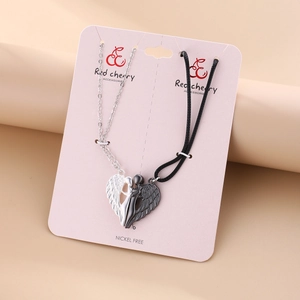 Detail of magnetic couple necklace with angel wing heart pendants and nickel free label