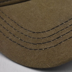 Close-up of a brown washed baseball cap showing reinforced stitching on the brim