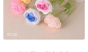 Close-up of handmade crochet roses in pink and blue with LOVE packaging