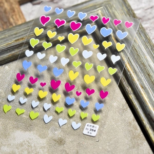 Pegatinas 5D japonesas de uñas con corazones coloridos y estrellas sobre film claro