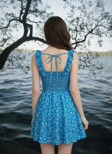 Detail of blue floral backless dress with adjustable ties and ruffled elastic waist