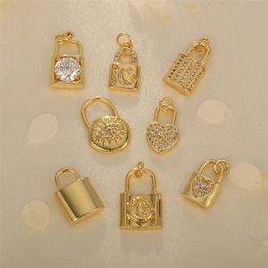 Gold heart and evil eye lock pendants with micro-pave cubic zirconia on beige fabric