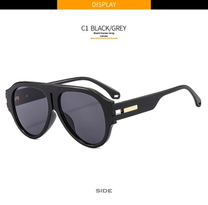 Detail view of black aviator sunglasses featuring a gold metal temple accent