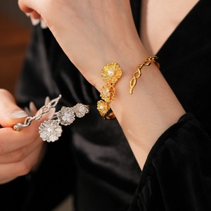 Macro view of vintage floral open bangle with pearls and sparkling zircon details