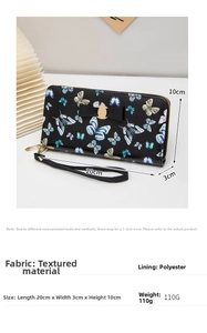 Detail of long wallet with butterfly print, metal bow buckle, and detachable wrist strap