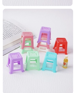 Close-up of colorful miniature dollhouse plastic stools in assorted bright colors