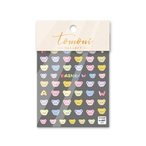 Detail of ultra-thin macaron bear nail art stickers with rainbow motifs on a grey sheet