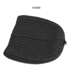 Inside view of black wool blend knit beanie showing soft ribbed texture and lining