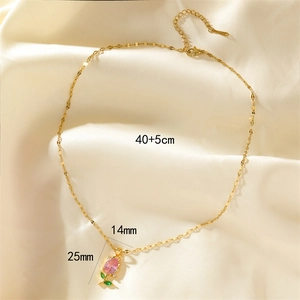 Elegant gold tulip necklace with pink cubic zirconia pendant on soft silk background