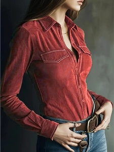 Macro detail of red long sleeve shirt with classic polo collar and metal buttons