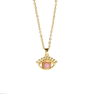 Detail of gold evil eye pendant necklace with a round pink gemstone centerpiece