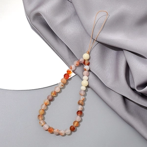 Detailed view of handcrafted agate beaded phone strap with colorful round stones on silk