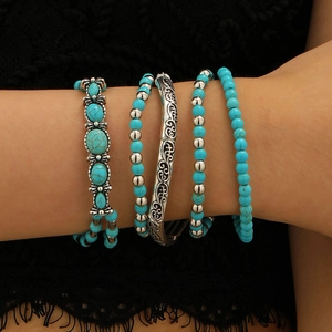 Detail of vintage turquoise bead bracelet set with retro engraved patterns on model wrist