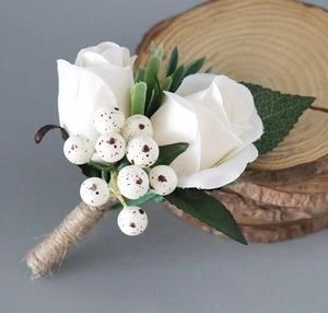 Detail of handmade white rose boutonniere with speckled berries and jute rope handle