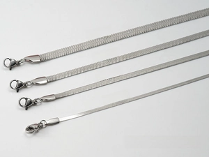Close-up of four stainless steel blade chains in 2mm to 5mm widths with lobster clasps