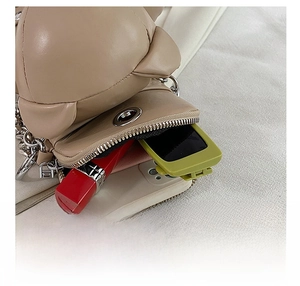 Detail showing the internal storage capacity for phone and lipstick in the bear bag