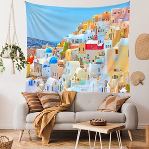 Detail of Santorini tapestry with blue-domed church hanging above a modern living room sofa