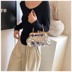 Detail of silver and blue sequined clutch bag with vintage gold metal clasp and chain