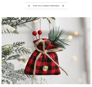 Christmas burlap gift bag with red buffalo plaid, bells and pine needles on tree