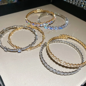 Detailed view of six-piece luxury bangle set with sparkling zircons in gold and silver finish