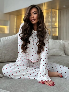 Detail of red heart print pajamas with fluted sleeves and red contrast overlock stitching