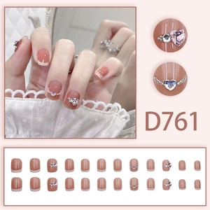 Close-up of D761 French press-on nails with pink hearts and silver pearl accents