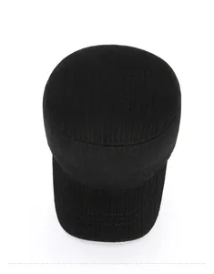 Top view of a black flat top military cap featuring textured fabric and a metal logo